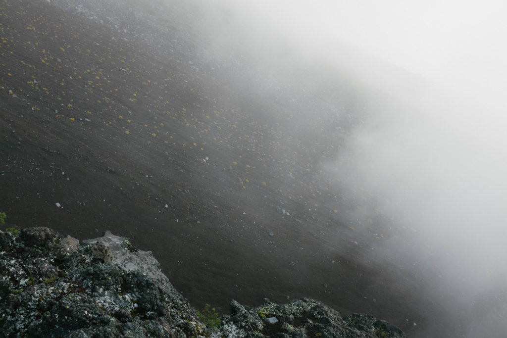 Mist covers the volcanic rock of Mt. Fuji.