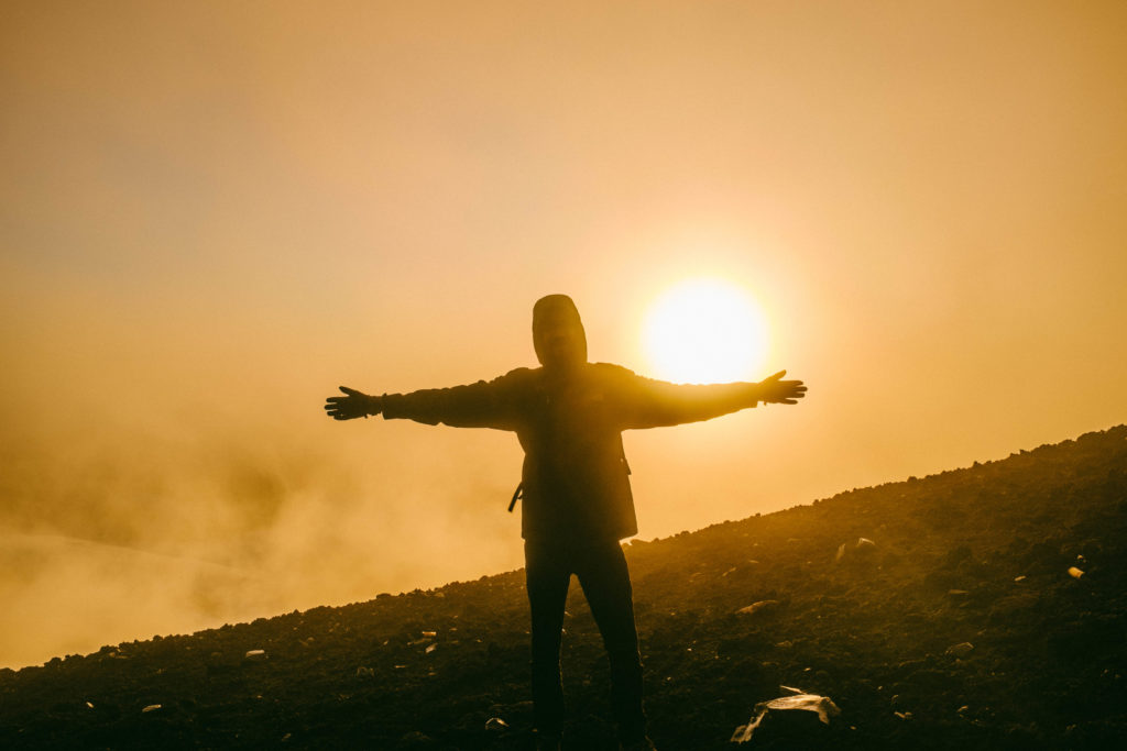 Experiencing the sunrise atop Mt. Fuji.