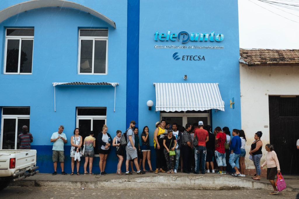 People queue in line for Cuban internet.